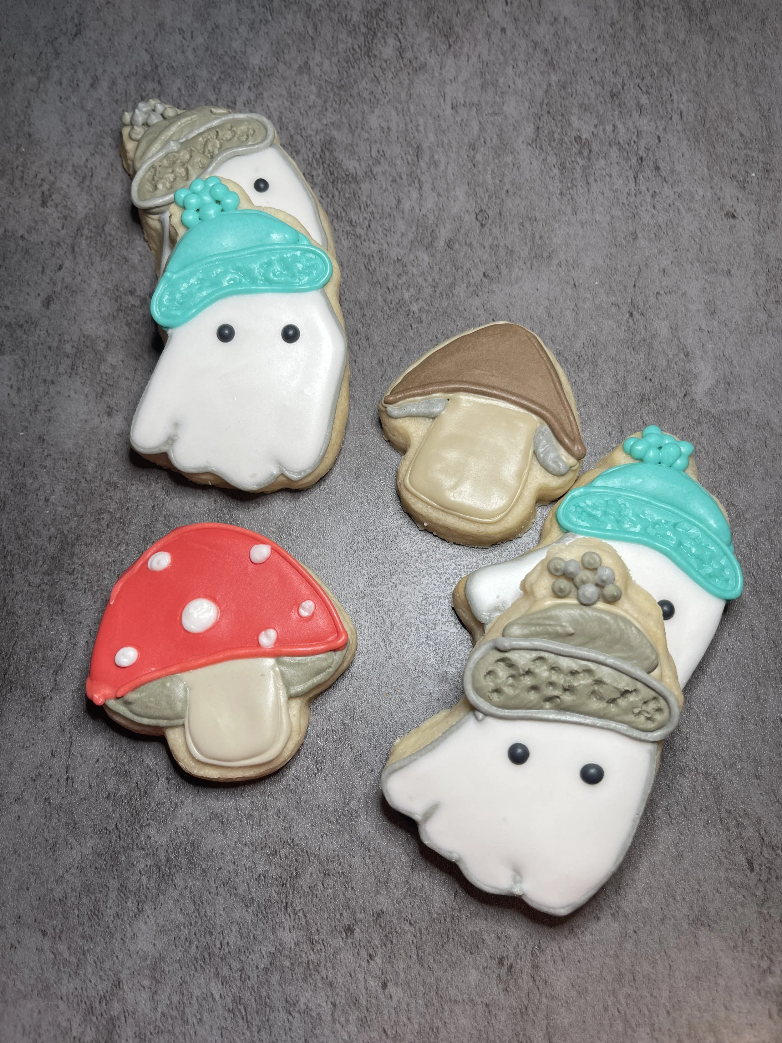 Mini ghosts in beanies with mini mushrooms