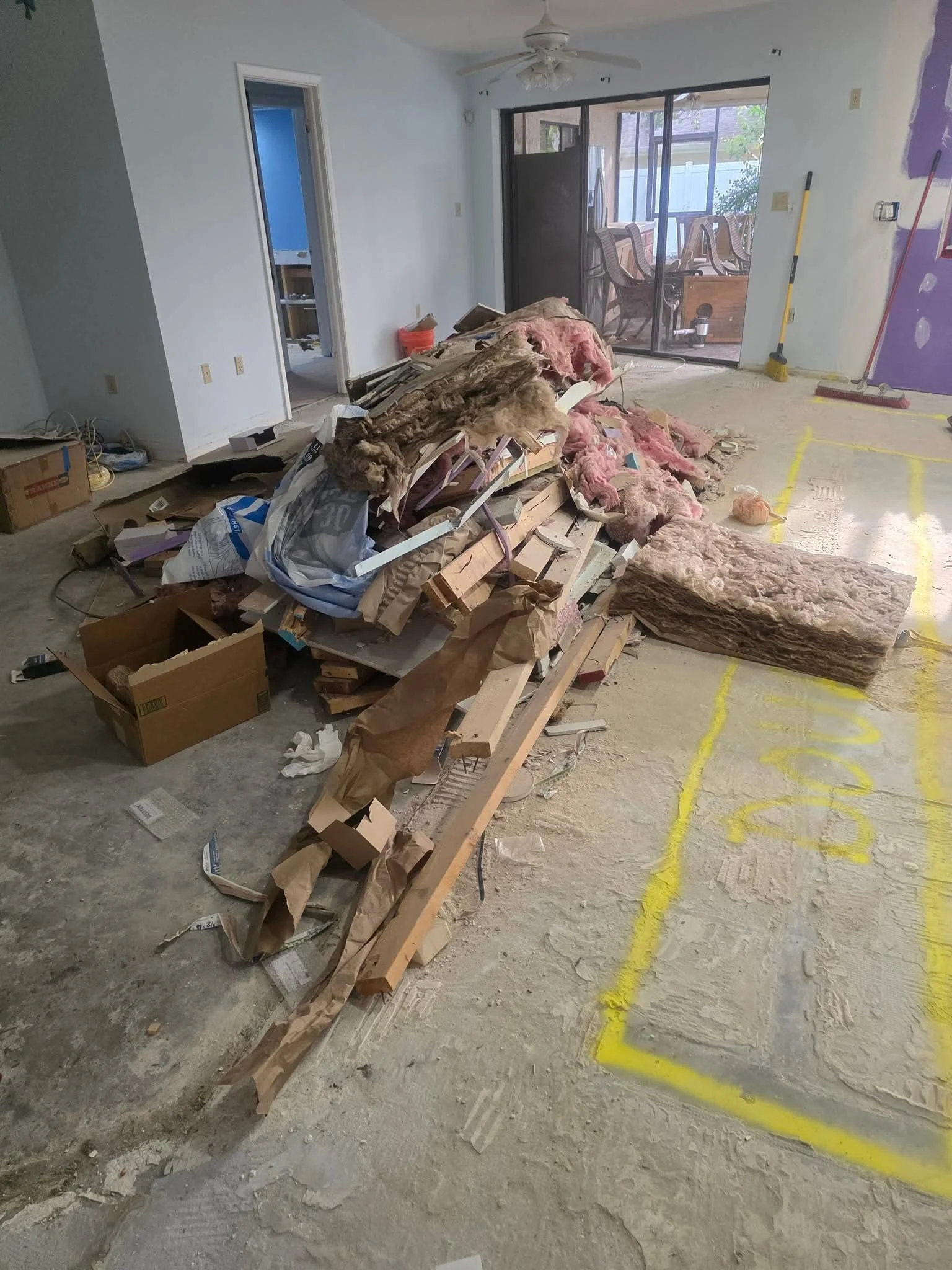 Construction debris including drywall, wood, and insulation removed by Suncoast Hauling Services