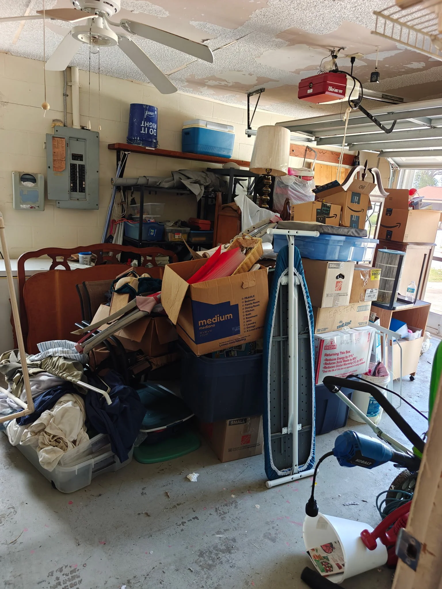 Cluttered garage filled with household items during a garage cleanout by Suncoast Hauling Services