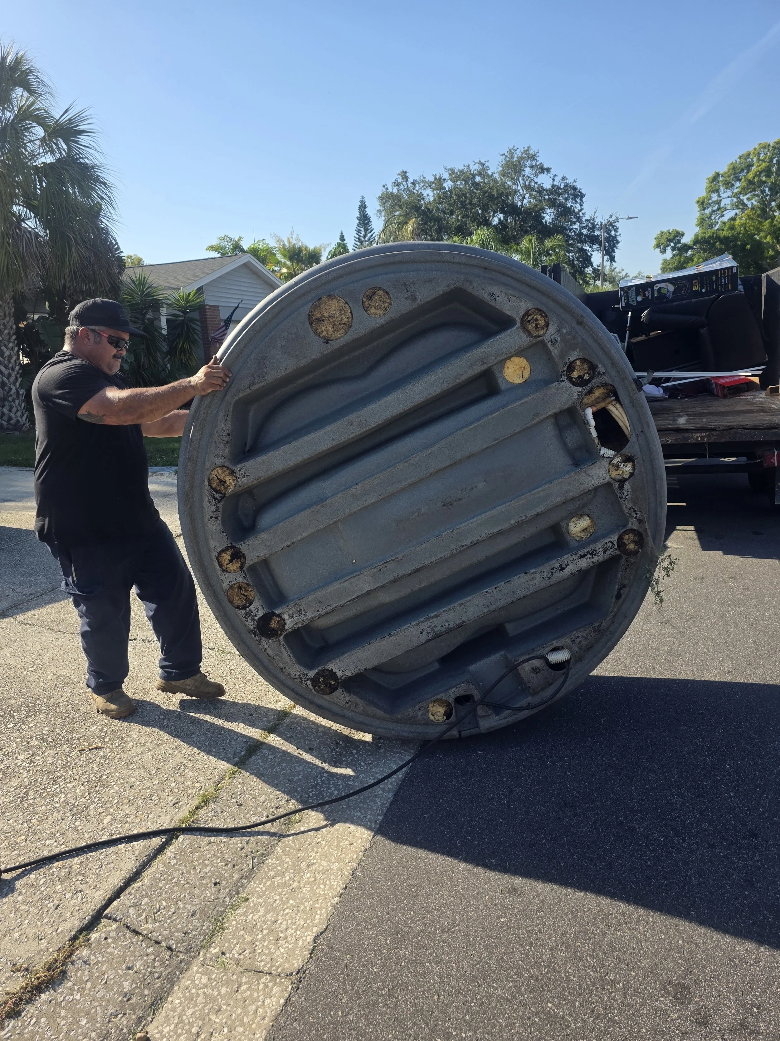 Suncoast Hauling Services removing a hot tub from a residential property