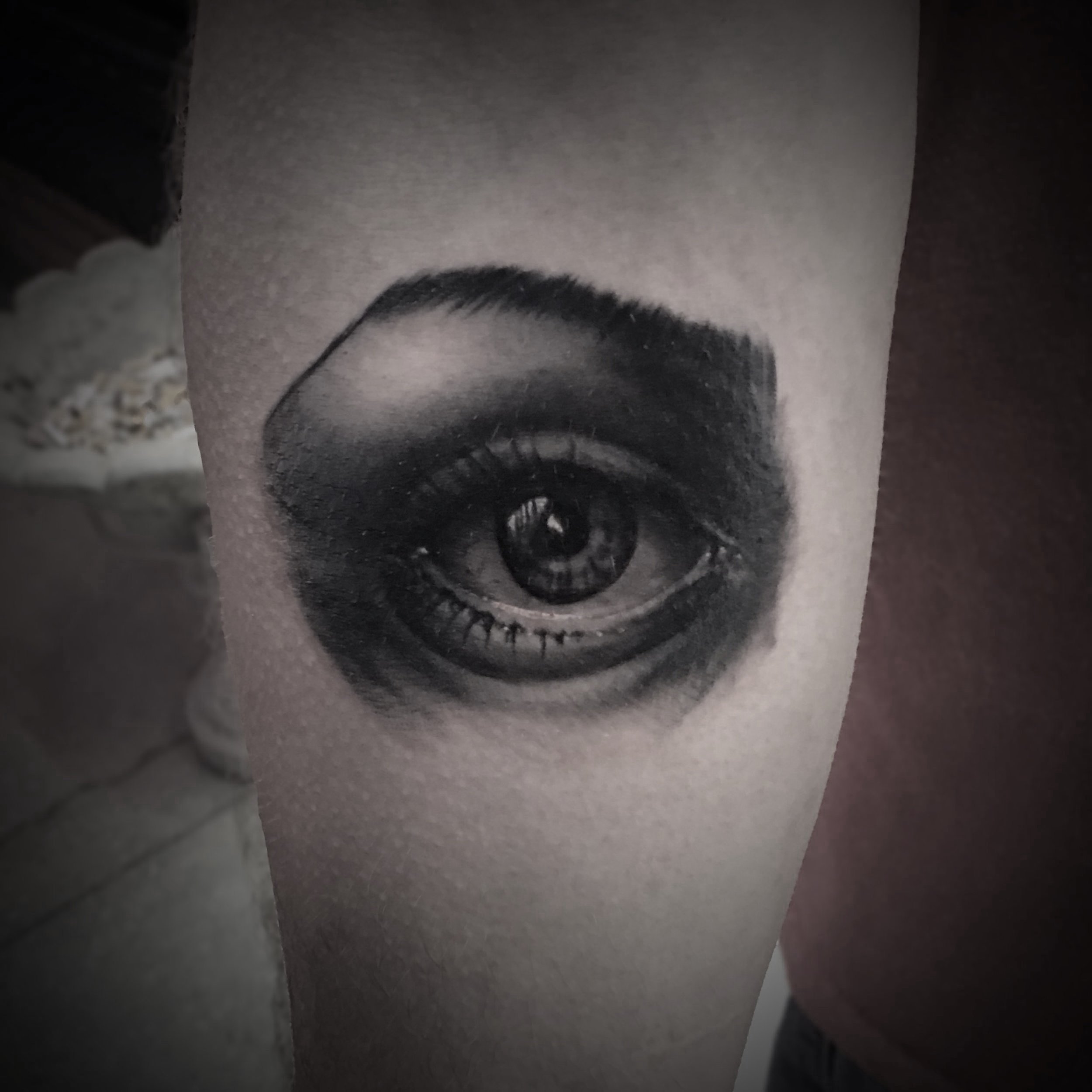 Tattoo of a realistic eye on a person's arm, detailed shading in black and gray. Tattoo, tattoo artist, tattoos, realistic tattoo, portrait tattoo, artistic tattoo, experienced tattoo artist, Oregon, tattoo artist near me, nature tattoo, tattoo shop,