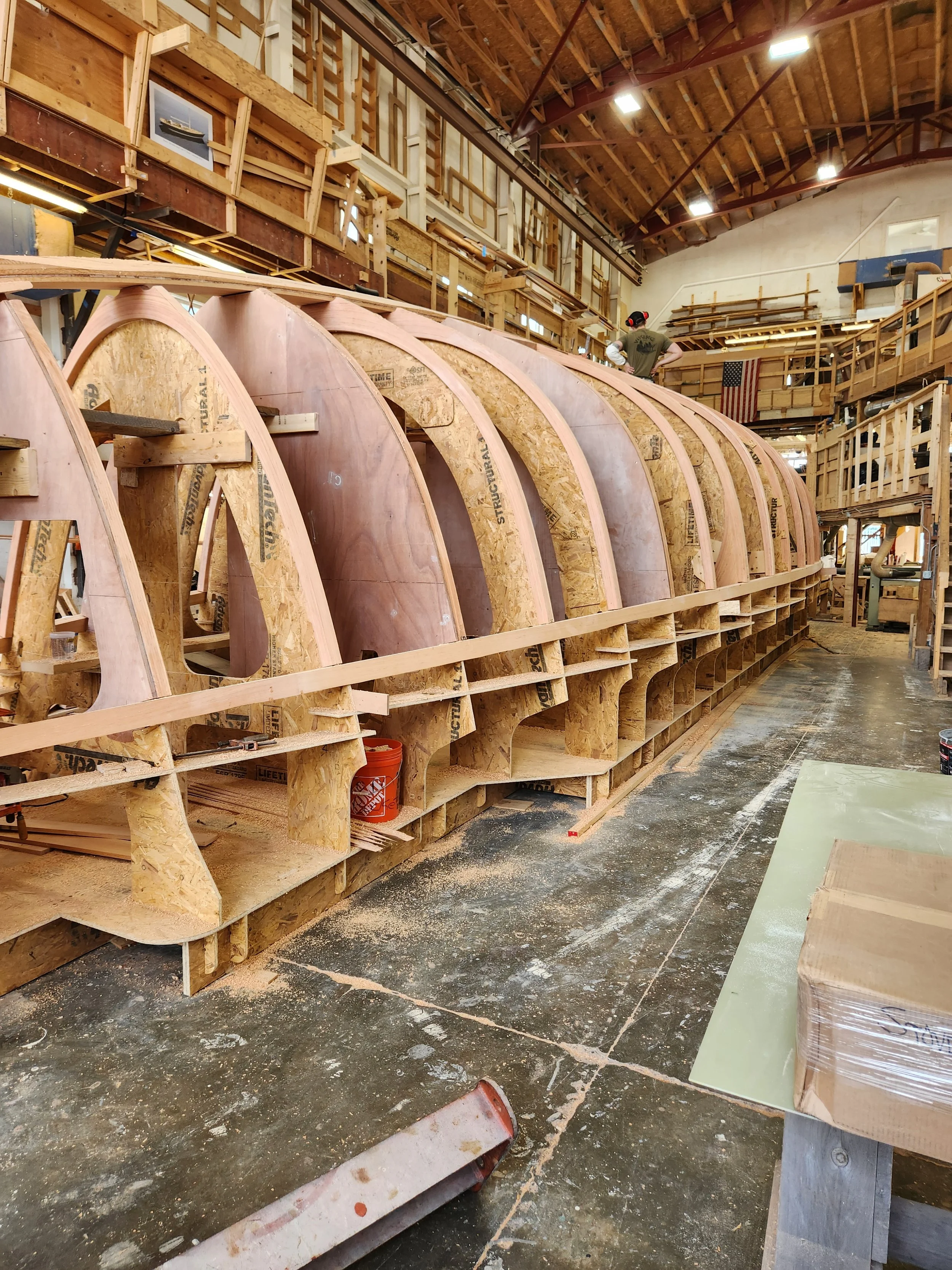 hewes-cnc-cut-large-wooden-boat-hull-construction-overhead.jpg