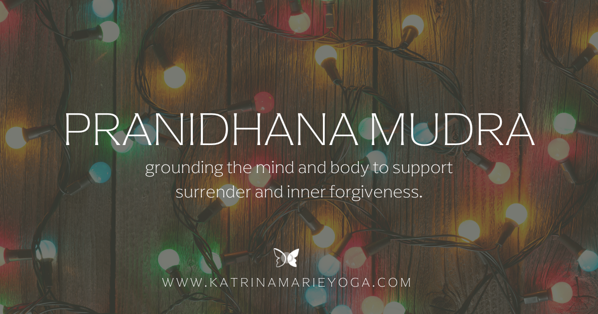 Pranidhana Mudra practice image with holiday lights and the title “grounding the mind and body to support surrender and inner forgiveness,” honoring Christmastime reflection and release.