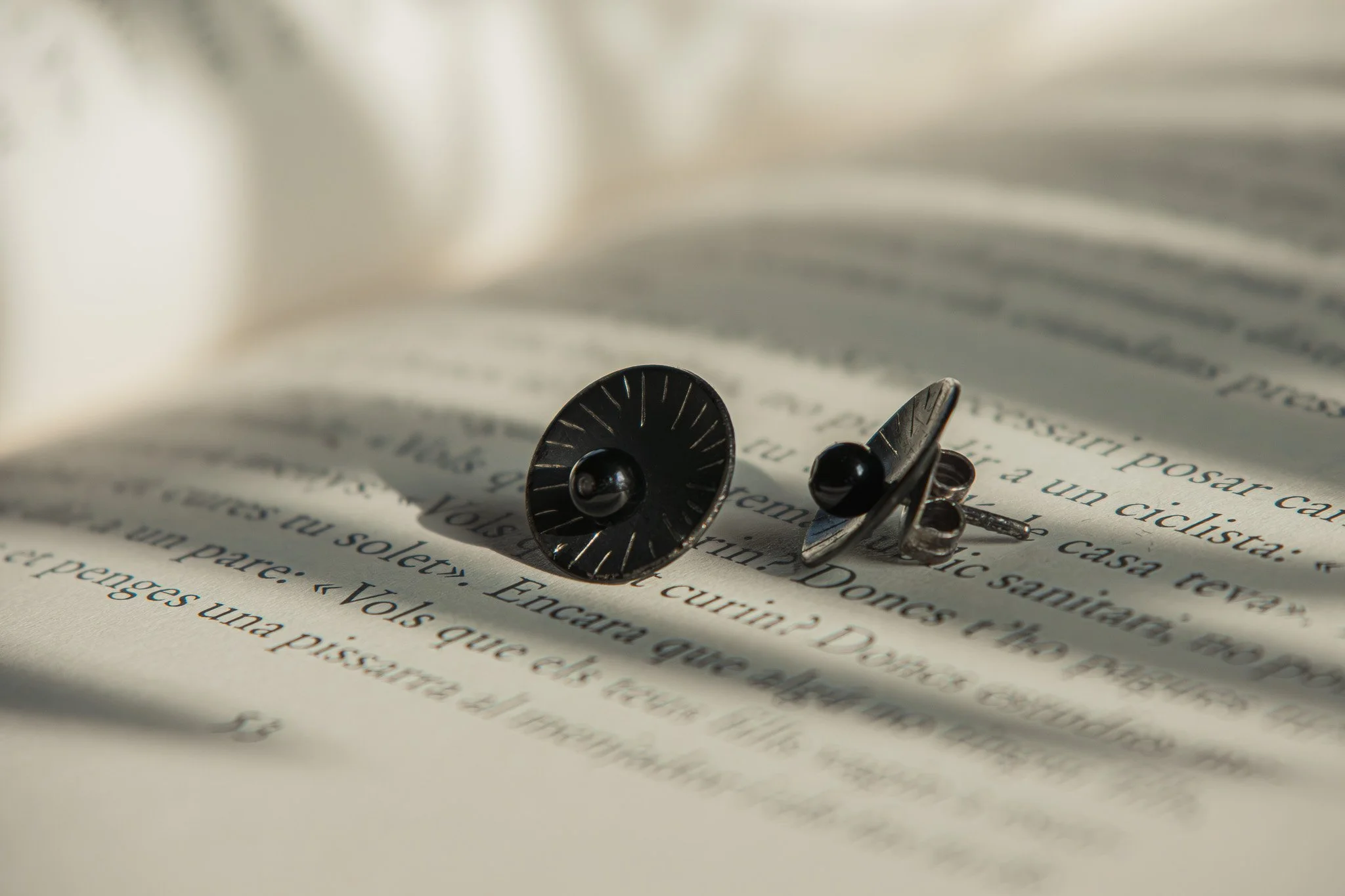 Unos gemelos de camisa en una página de un libro abierto