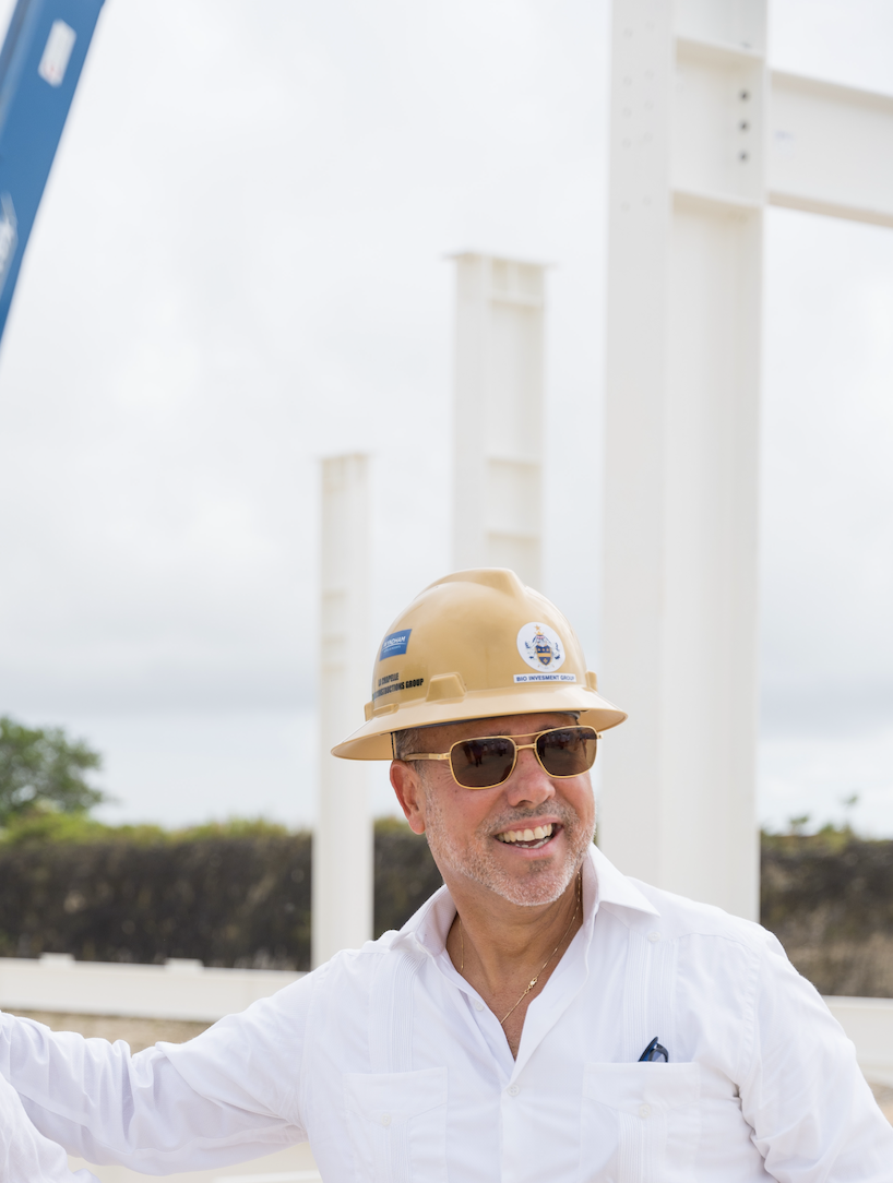 Nigel p. La cahpelle  wearing a hard hat and sunglasses at an active site, overseeing real estate development and infrastructure projects in the Caribbean."
