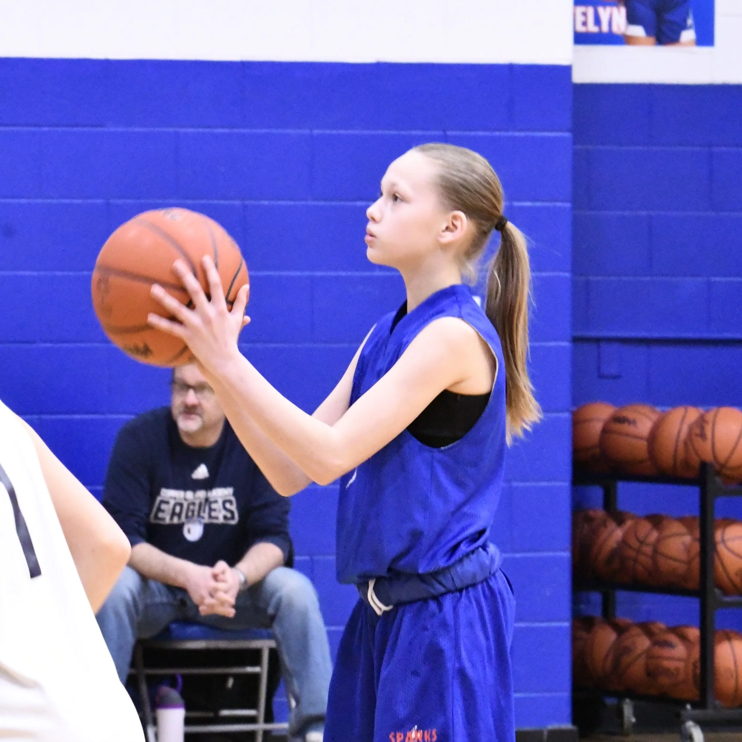 Elementary girl shooting a freethrow.