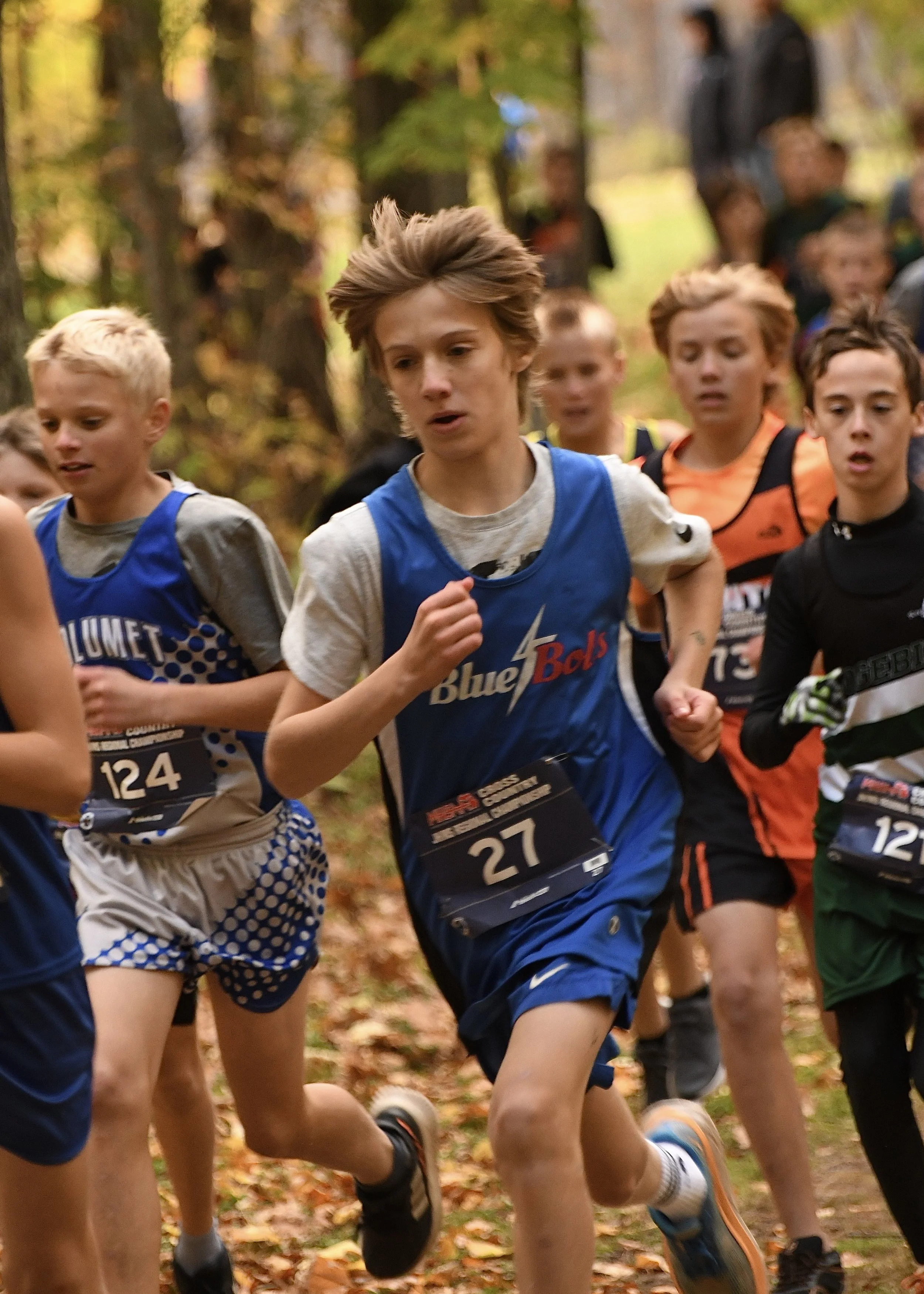 Close up of a junior high Dollar Bay cross country runner leading a pack of opponents at the beginning of a race.. 