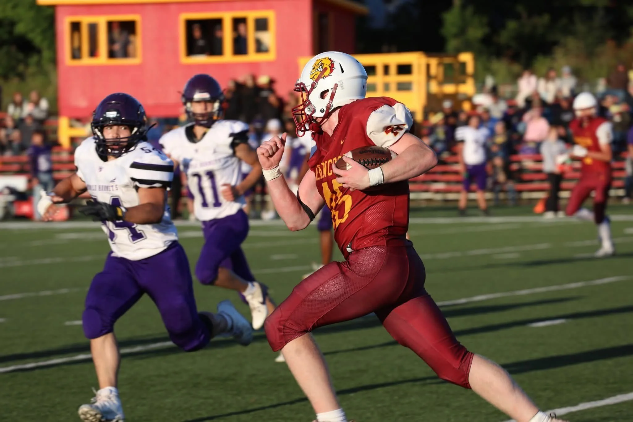 Dollar Bay football player being blocked as he attempts to get around his opponent.