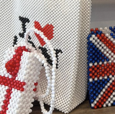 Decorative beaded artwork featuring a Union Jack flag and the phrase "I ❤️" on a white surface.