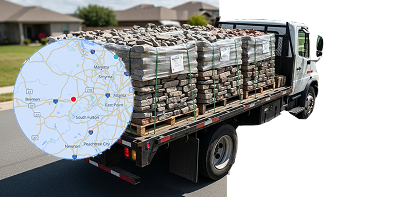 Flatbed truck loaded with stacked bricks and stones parked on a suburban street.