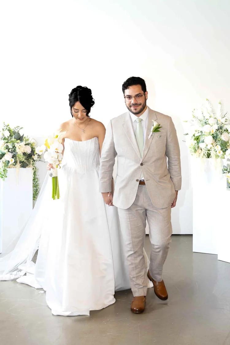 Bride and groom walking hand in hand after their wedding ceremony in Longmont, Colorado