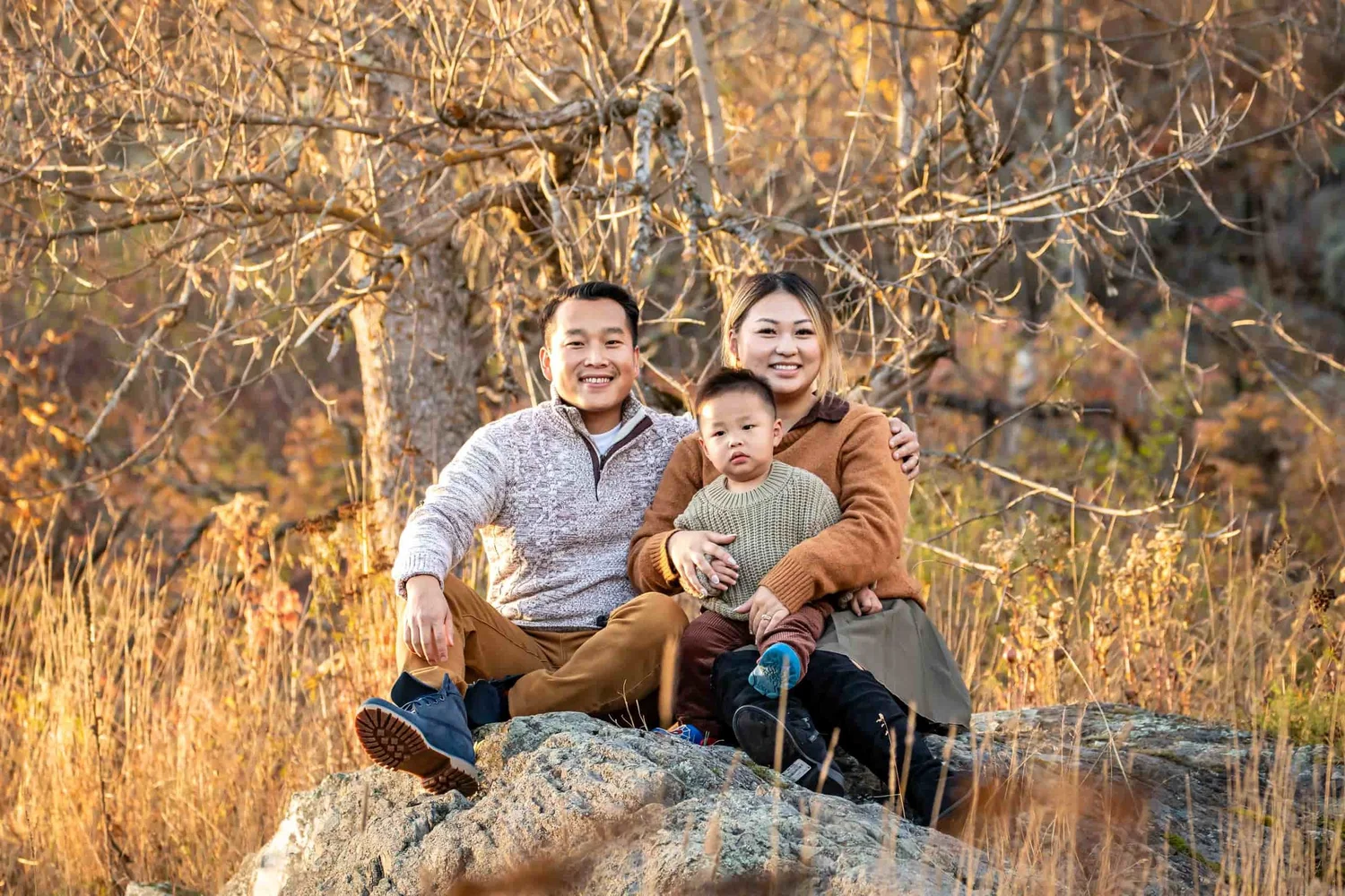 Parents holding their young child during an outdoor family photography session by Denver photographer Grayson Harris