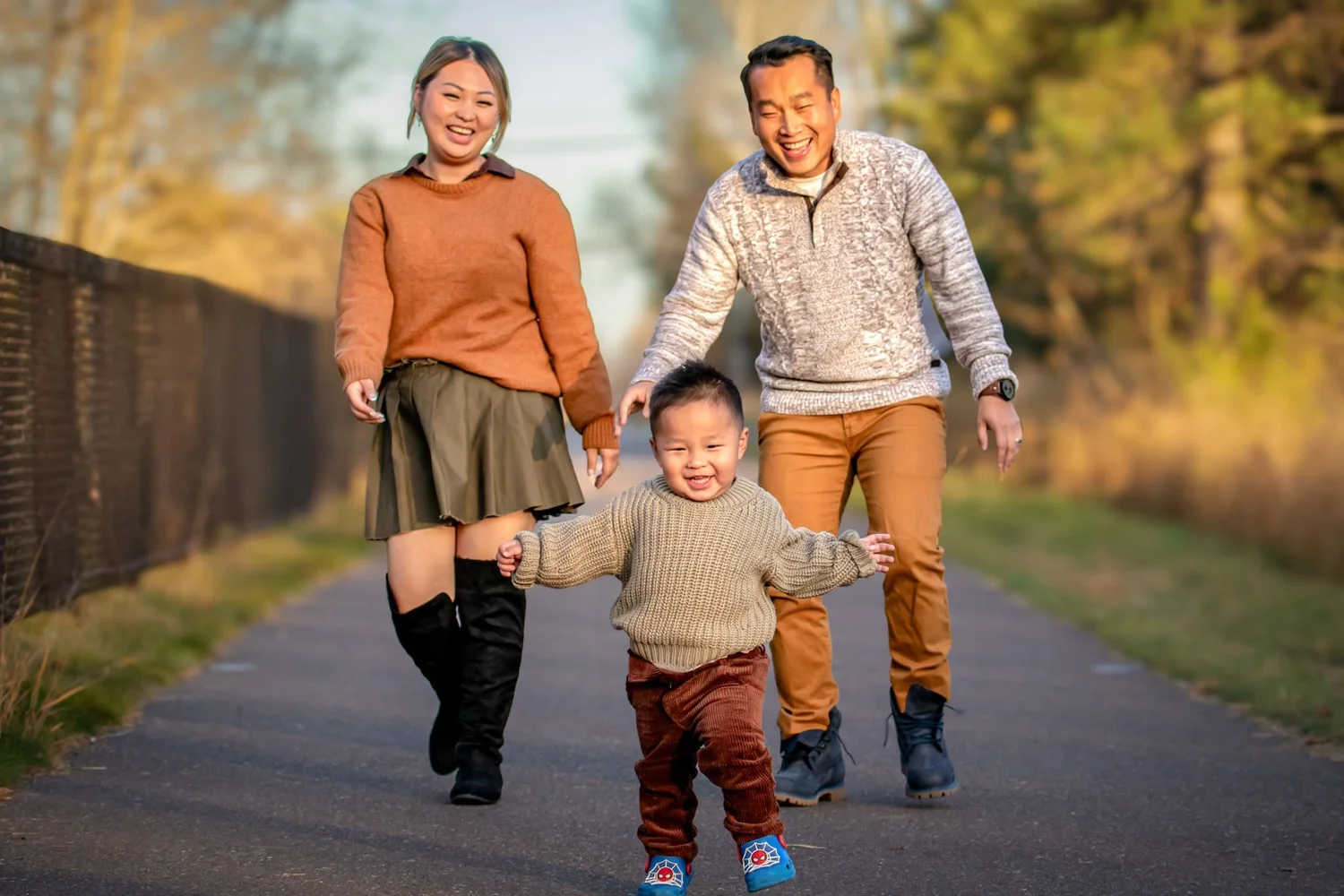 Happy family walking together during an outdoor Denver family portrait session