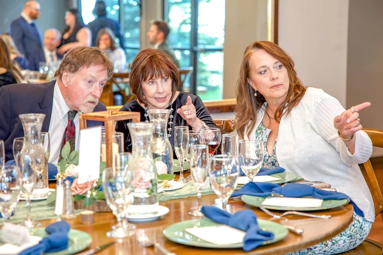 Guests sharing a conversation during a formal dinner event in Colorado