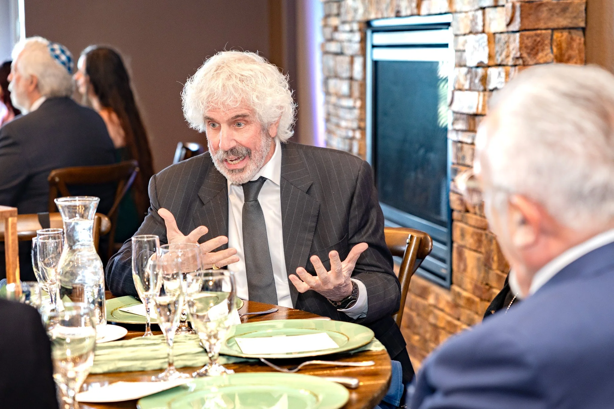 Guest speaking during a conversation at a formal event in Colorado, photographed by Grayson Flicks Photography.