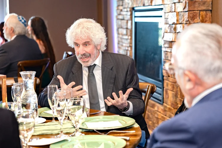 Guest speaking during an engaging conversation at a formal event in Colorado