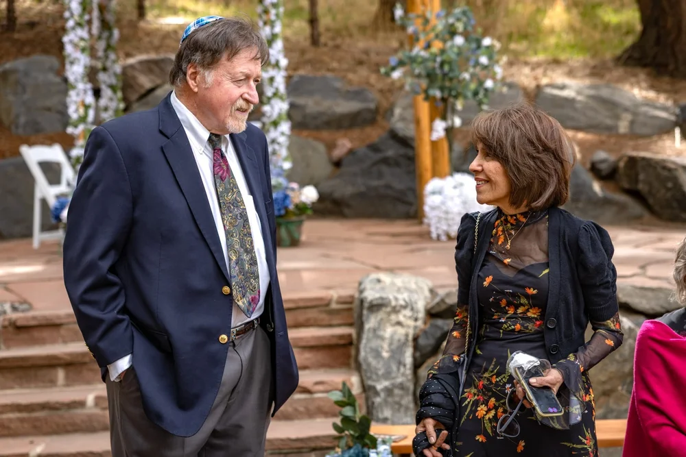 Two guests talking during an outdoor Colorado event
