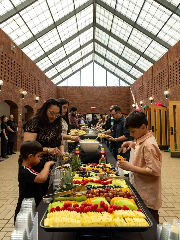 Guests enjoying a catered buffet during an indoor community event in Colorado