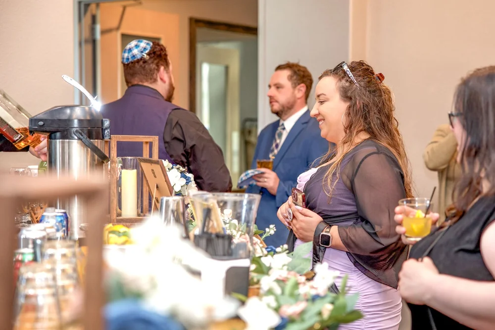 Guests socializing during a cocktail hour at an indoor Colorado event