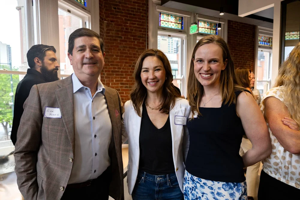 Three attendees posing for a portrait during a Colorado networking event