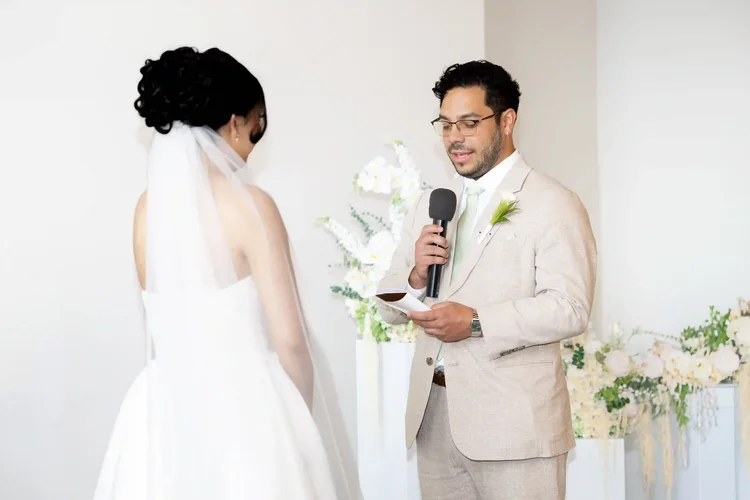 Groom reading his vows into a microphone at a Longmont, Colorado wedding ceremony