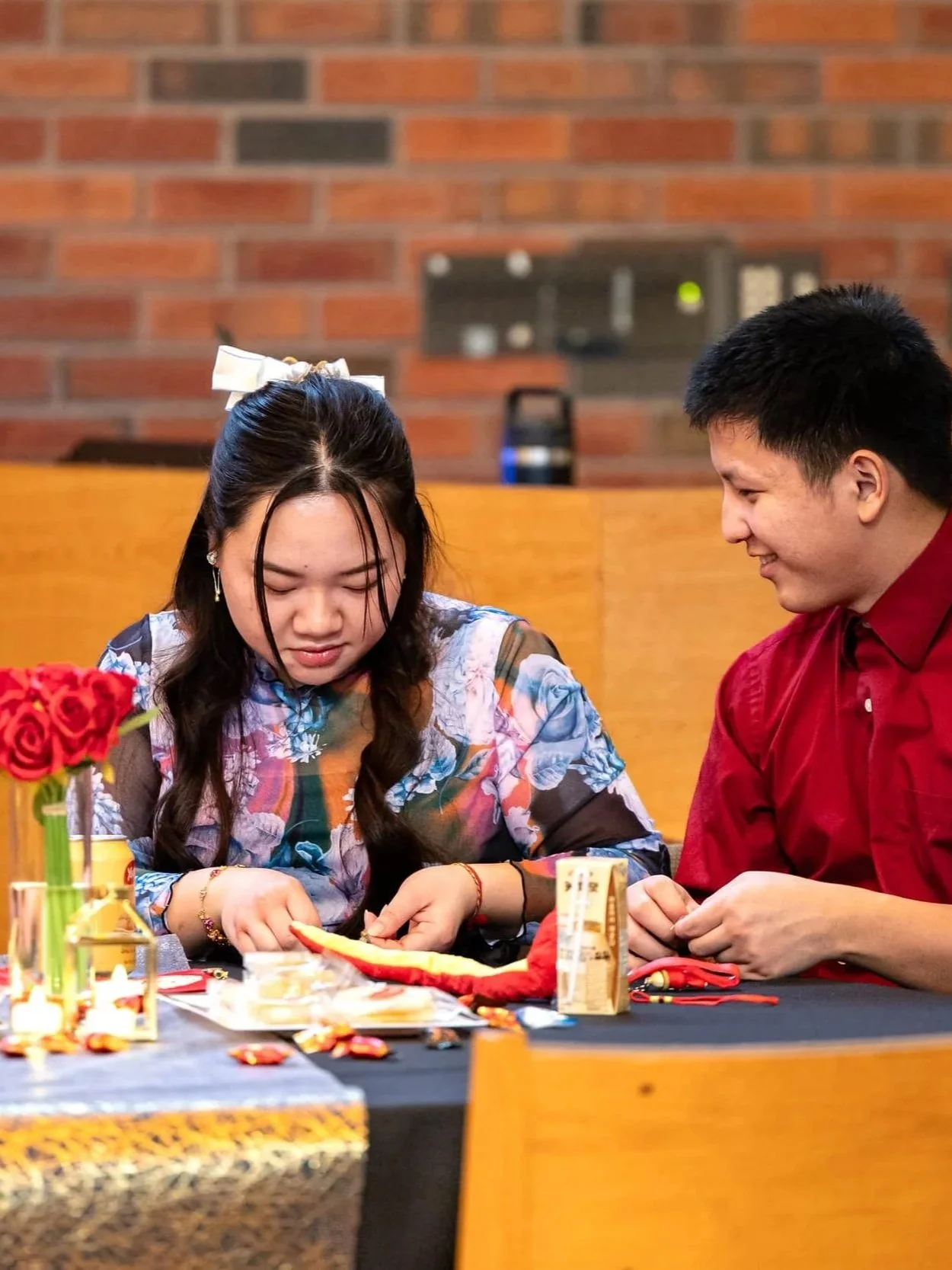 Two attendees participating in an activity during an indoor community event in Colorado, photographed by Grayson Flicks Photography.