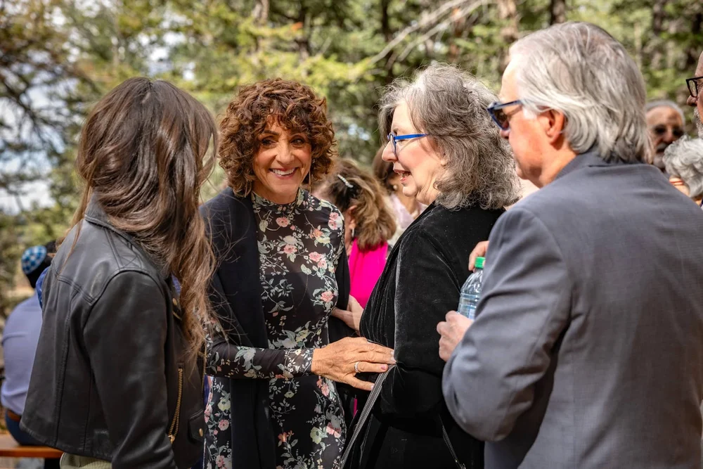 Attendees talking during an outdoor professional networking event in Colorado