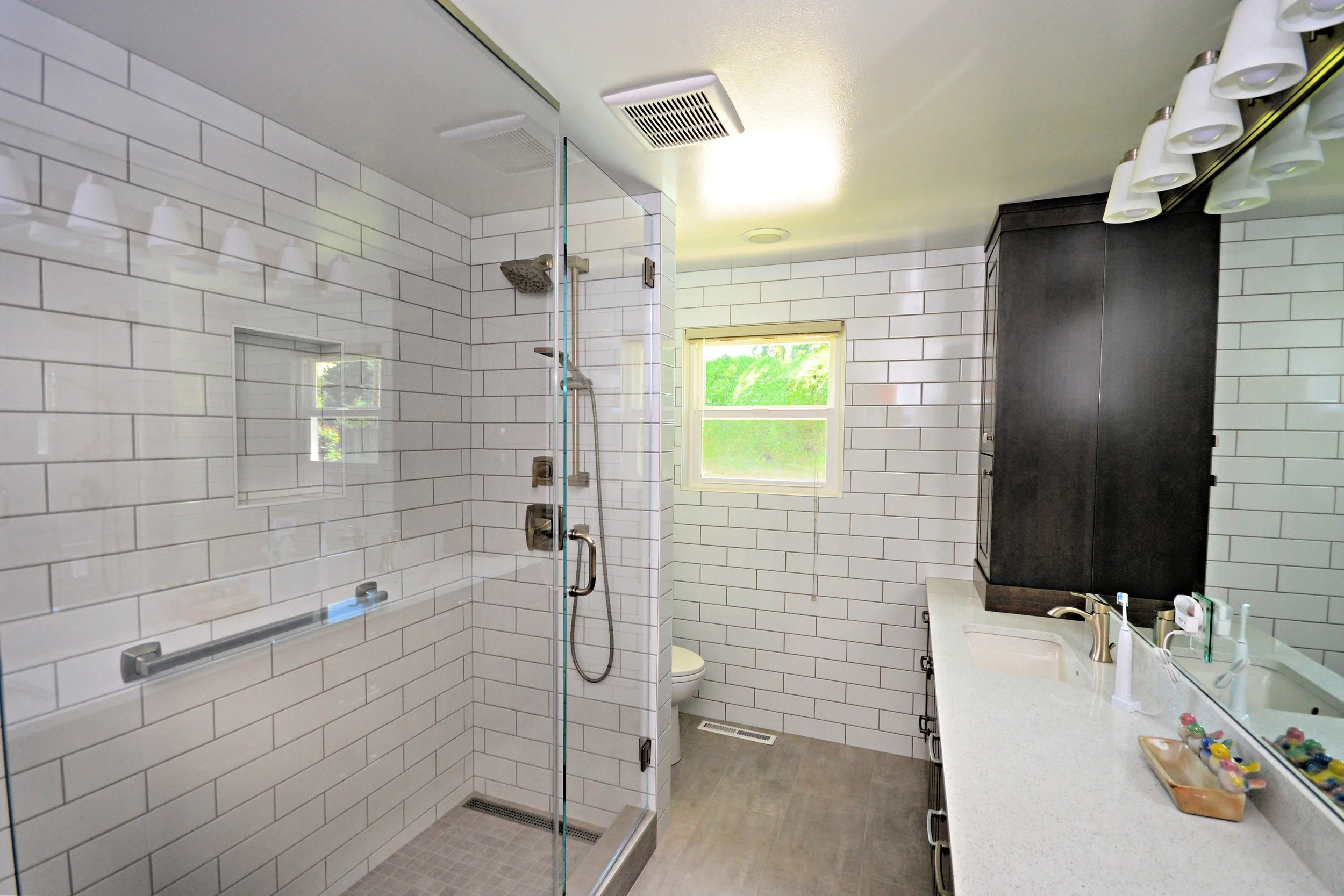 Subway tile with gray grout shower and bathroom walls.