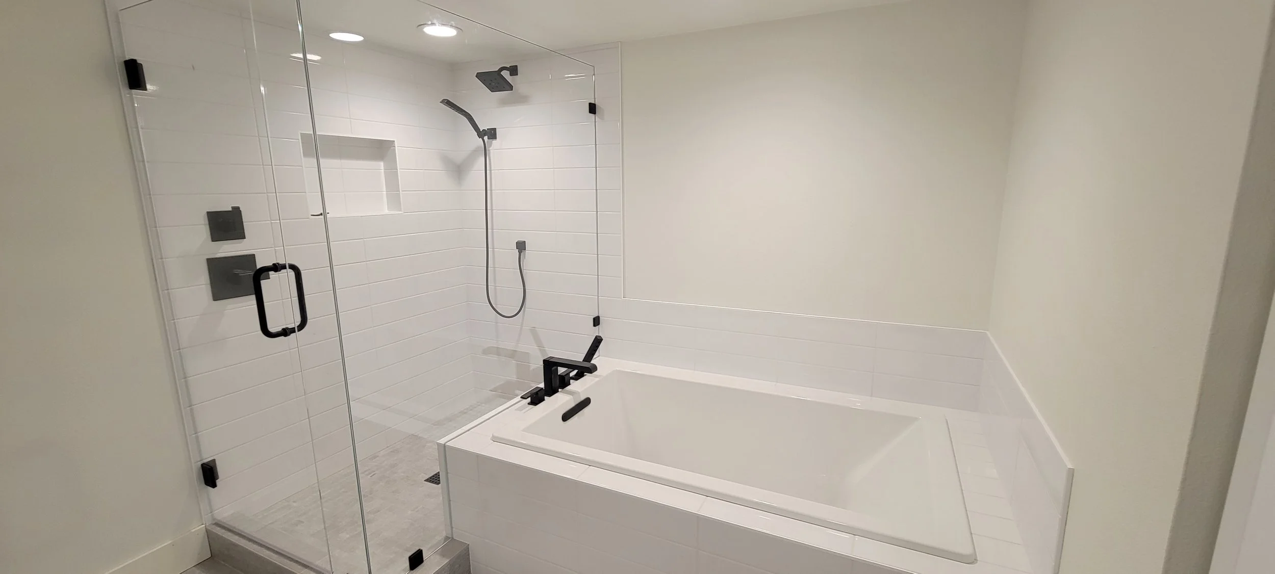 Soaker tub with attached walk-in shower. Oil rubbed bronze finishes.