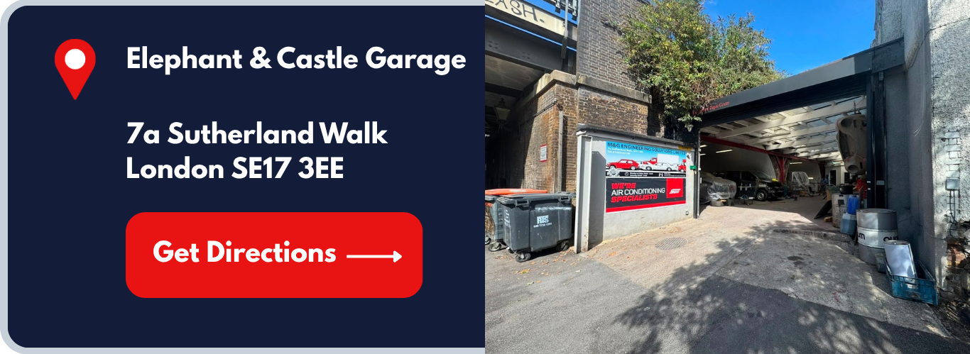 Sign for Elephant & Castle Garage at 7a Sutherland Walk, London SE17 3EE with an arrow button labeled 'Get Directions', next to an urban garage with cars parked inside and outside, garage entrance has various equipment and barrels.