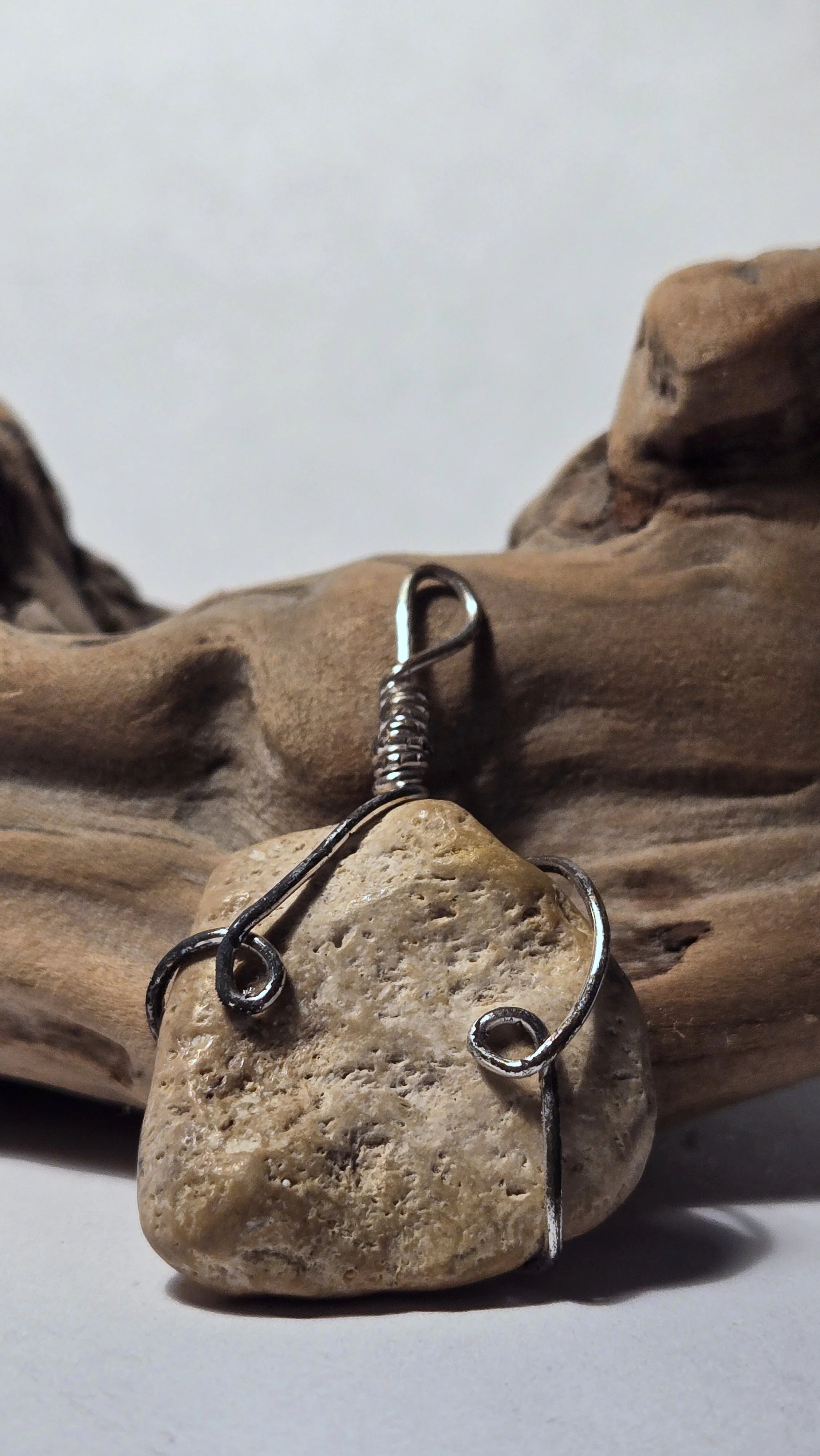 Shiny brown rock pendant with silver wire