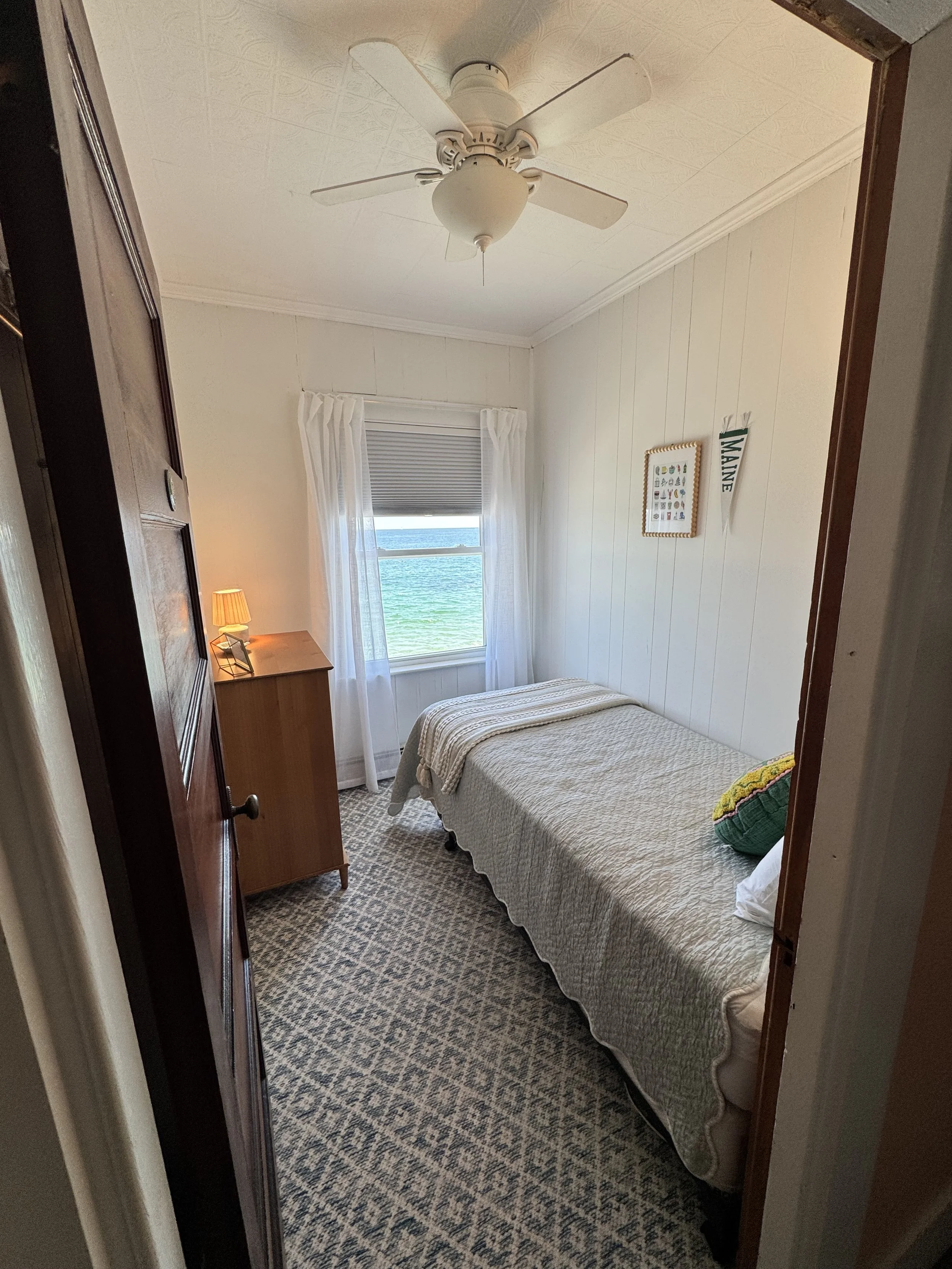 Bedroom #4 features updated decor, a twin bed and ocean views. 