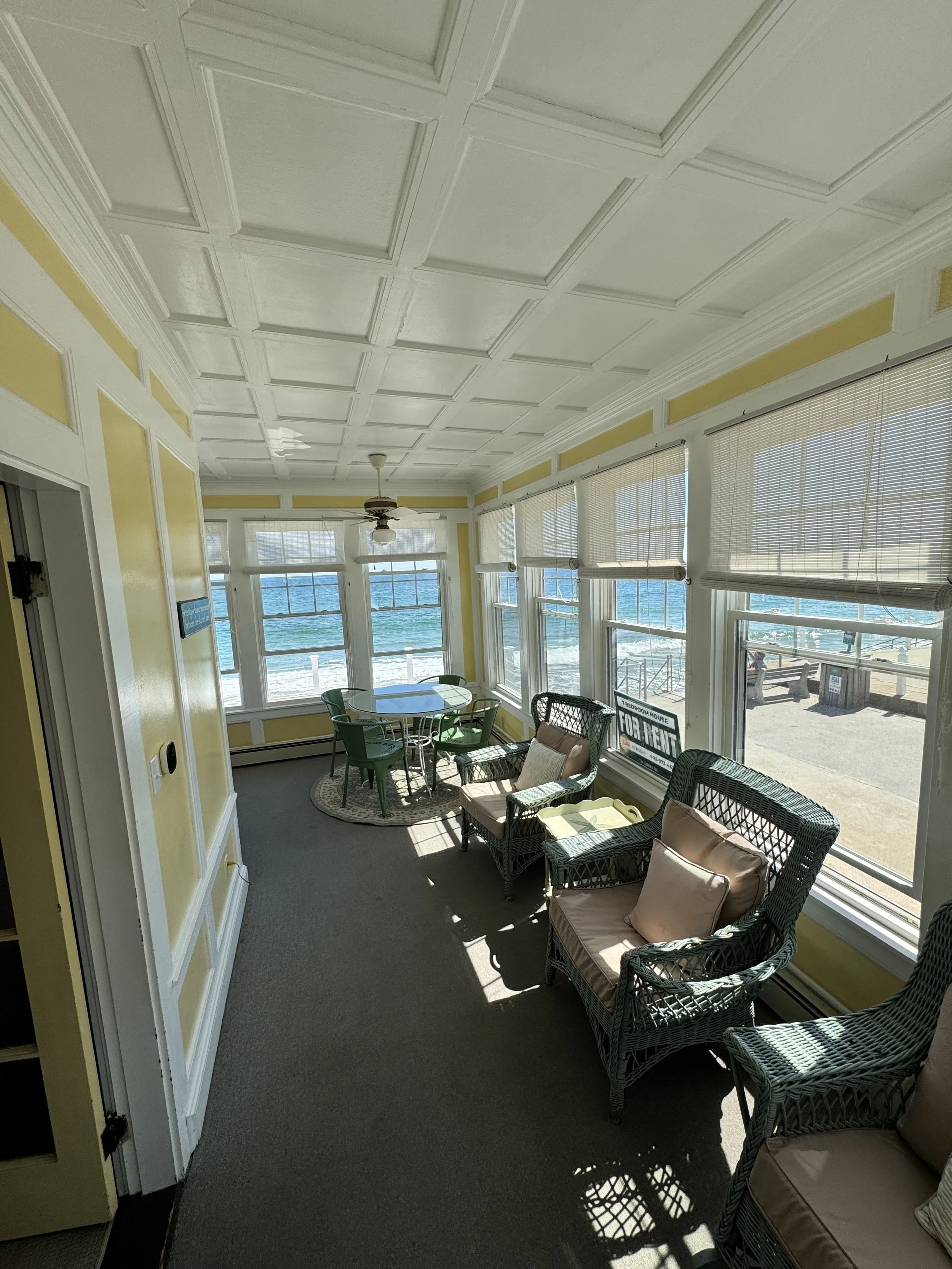 The sunroom offers views of the ocean from every window. 