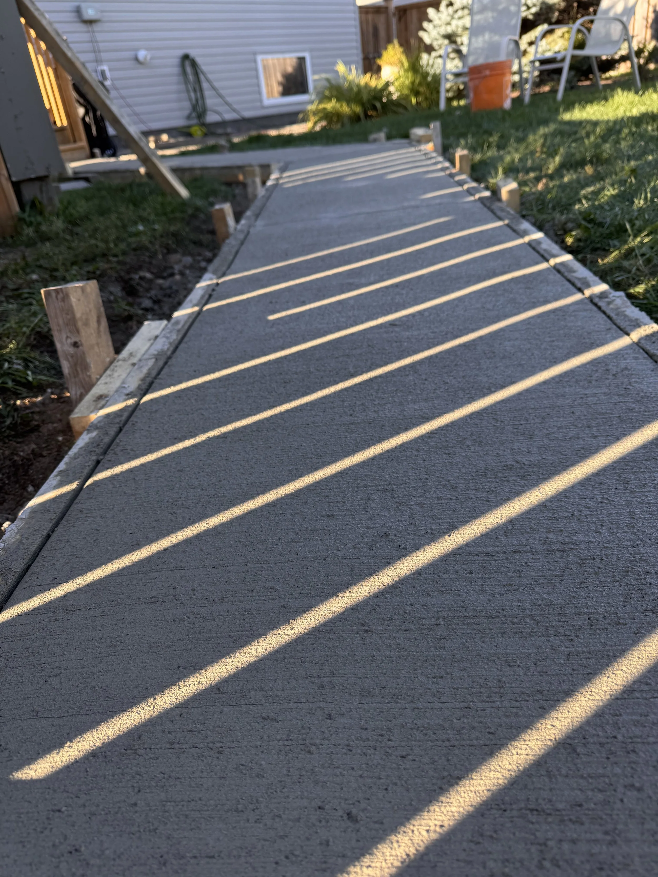 Newly poured concrete sidewalk with wooden forms in Thunder Bay, Ontario