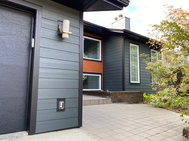Iron Gray Hardie Plank installed with a Lux Panel accent in Edmonton