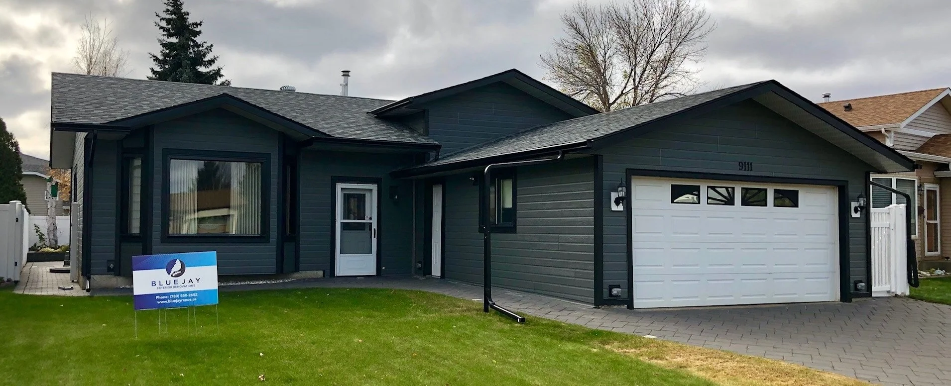 Edmonton home with a renovated exterior featuring Canexel siding in charcoal with black accents.