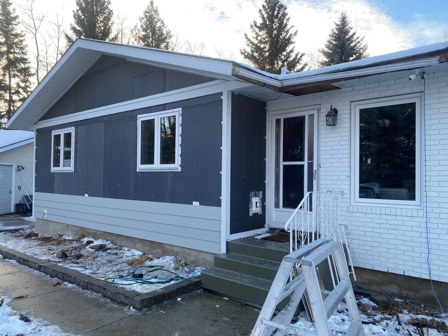 This photo shows a layer of exterior insulation installed beneath James Hardie siding.