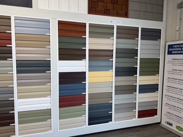 Display of vinyl siding colour options at the Blue Jay Exterior Renovations showroom.