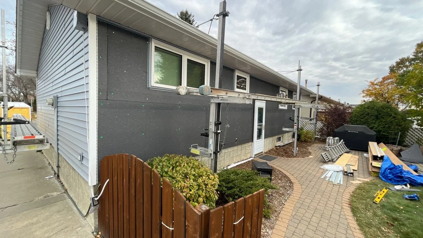 Edmonton bungalow mid exterior renovation with vinyl siding being installed over exterior insulation
