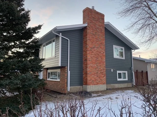 Iron Gray Hardie Board on a home with a red brick accent Edmonton