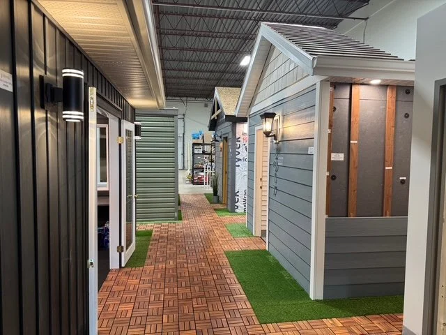 The Blue Jay Exterior Renovations warehouse village, with model homes featuring siding, exterior insulation, and soffit installations.