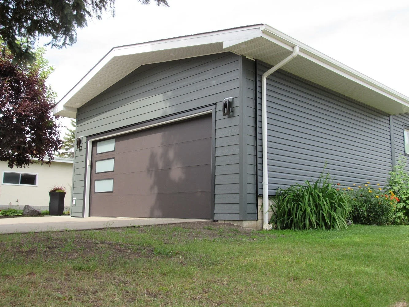 Modern looking exterior renovation on an Edmonton home with vinyl siding and Hardie board.
