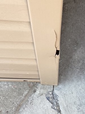 A cracked Vinyl Corner Post that needs replacement