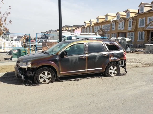A car melting from Mckenzie Town Fire damage
