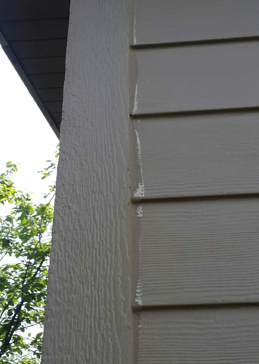 Faded, poorly applied caulking on a Hardie Siding install