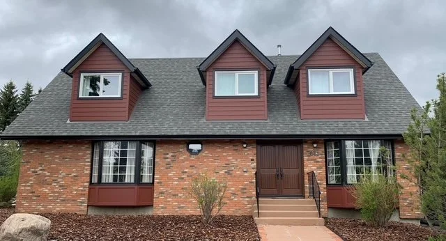 Countrylane Red Hardie Siding Installed on a two storey Edmonton Home with orange brick accents