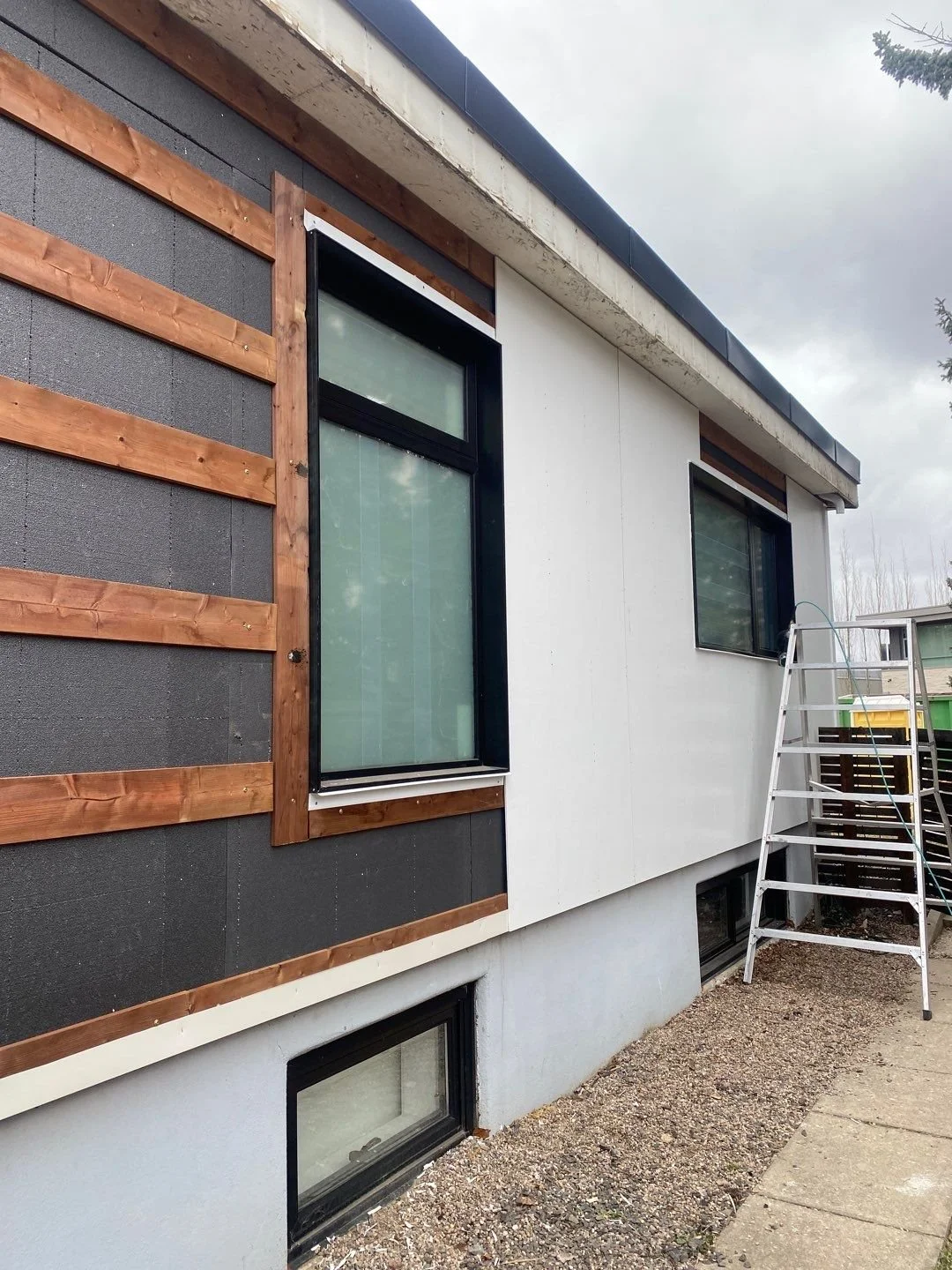 Hardie Panel Going Up Over Strapping and Enerspan Insulation Panels