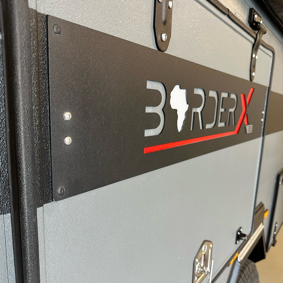 Close-up of a black and gray panel with '3 RDEX' and an outline of Africa in white on it.