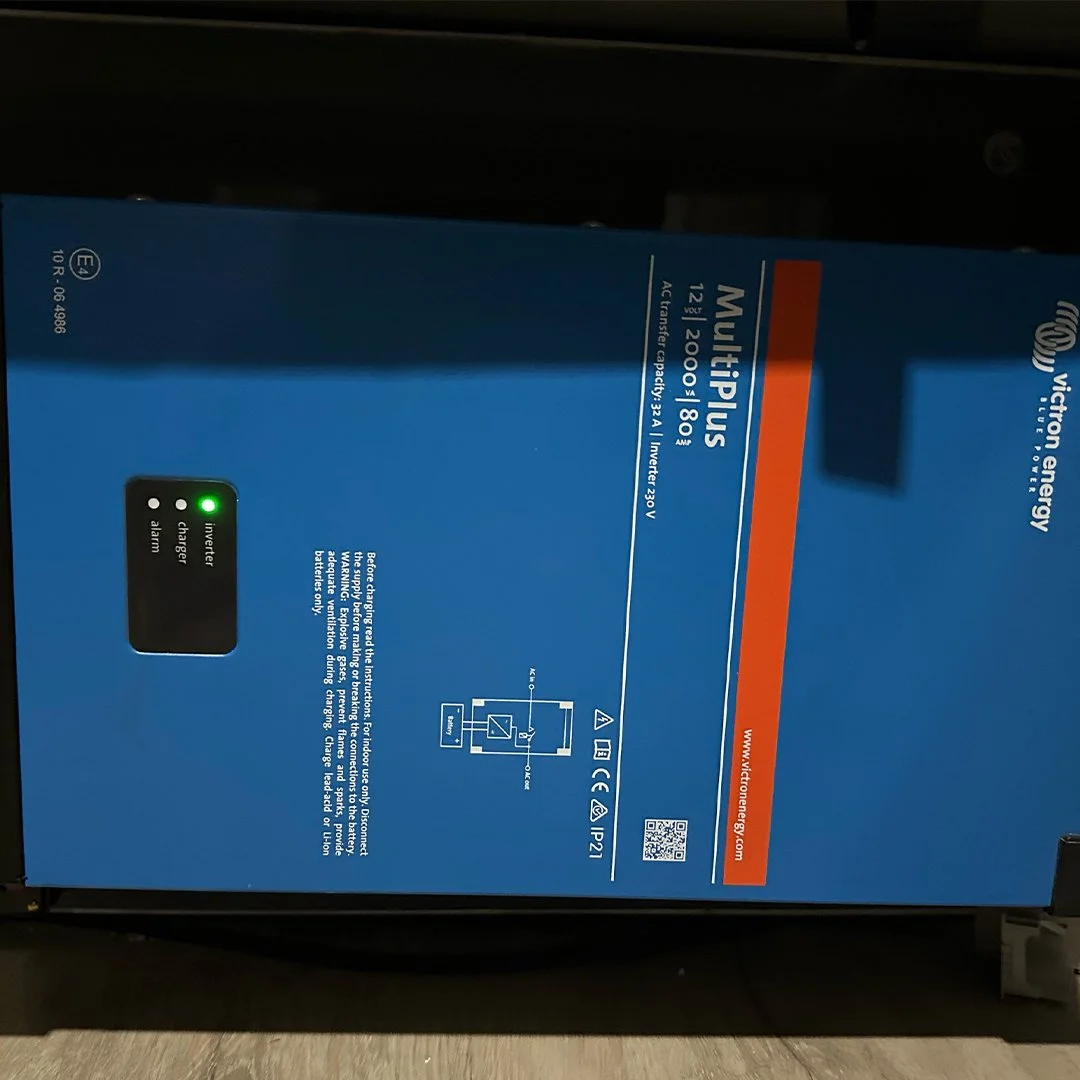 Blue box of Victory Energy Multiplus dual power inverter and charger with indicator lights and system diagram.