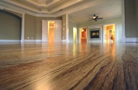 Empty room with hardwood flooring and open doors, ceiling fan. Roofing and painting in Bucks County